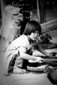 Local Boy, sieving grain, Thailand, travel, travel photographer, travel photography